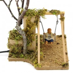 Moving Child on swing in dressed terracotta 10 cm