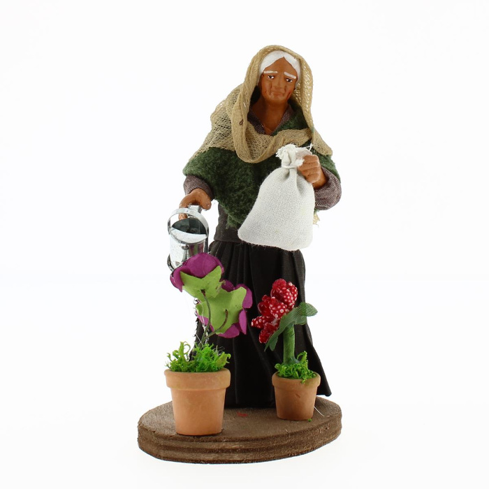 Woman watering plants in dressed terracotta 12 cm