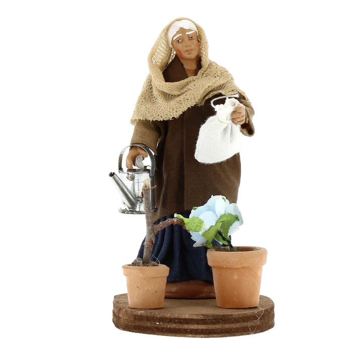 Woman watering plants in dressed terracotta 10 cm