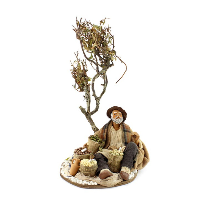 Mercante seduto sotto l’abero in terracotta vestita 24 cm