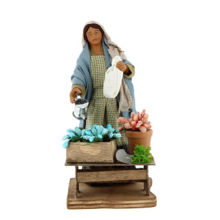 Woman watering plants in dressed terracotta 15 cm