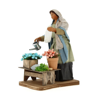 Woman watering plants in dressed terracotta 15 cm