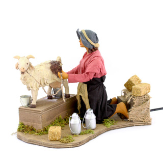 Donna che munge capra in terracotta vestita a movimento 24 cm