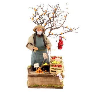 Fruttivendolo con bilancia in terracotta vestita a movimento 24 cm